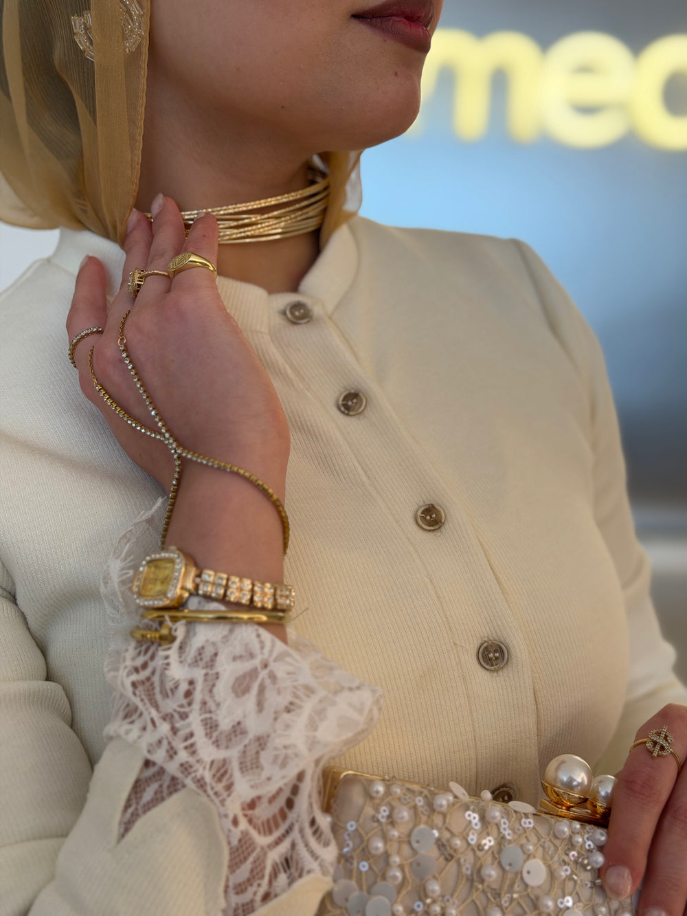 Earrings, bangles and a belt laid on knit